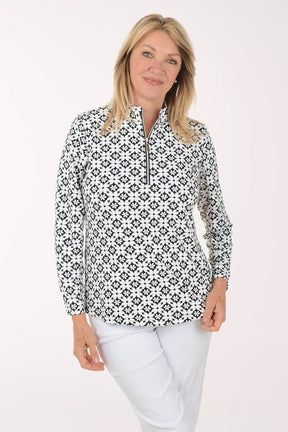 Woman wearing a black and white patterned shirt on a white background