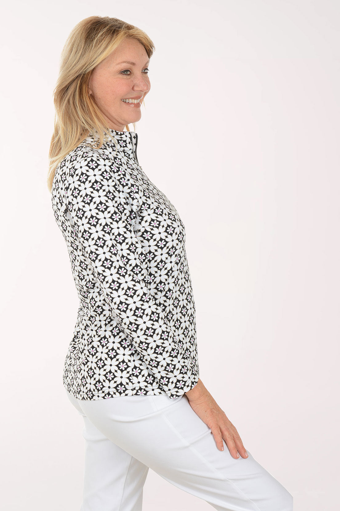Woman wearing a black and white patterned shirt on a white background