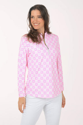 A woman wearing a long sleeve pink and white flower activewear top.
