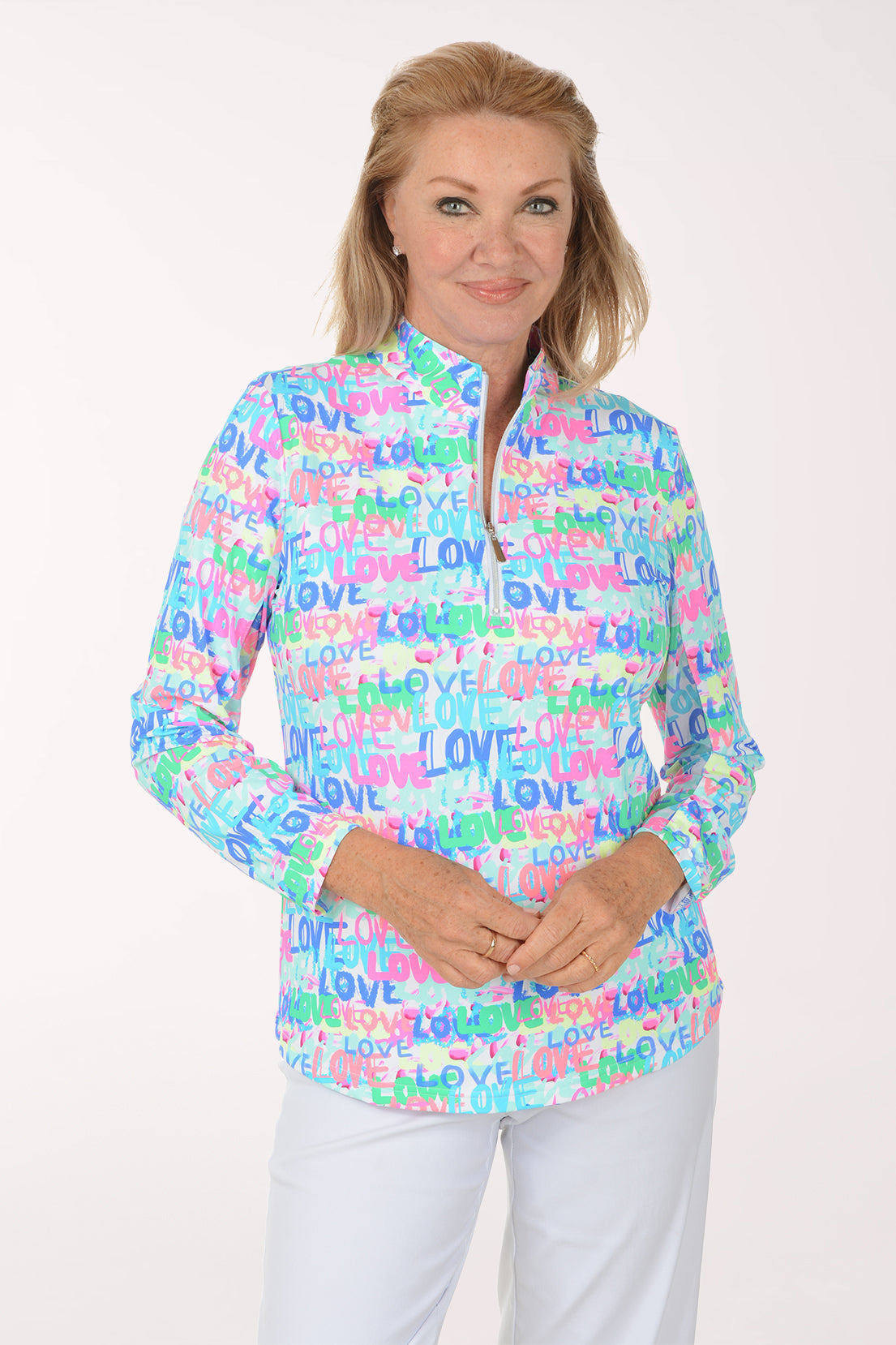 Woman wearing a colorful 'LOVE' patterned shirt on a white background