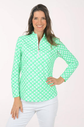 A woman wearing a long sleeve green plaid activewear top.