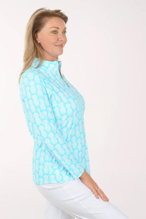 Woman wearing a light blue patterned shirt on a white background