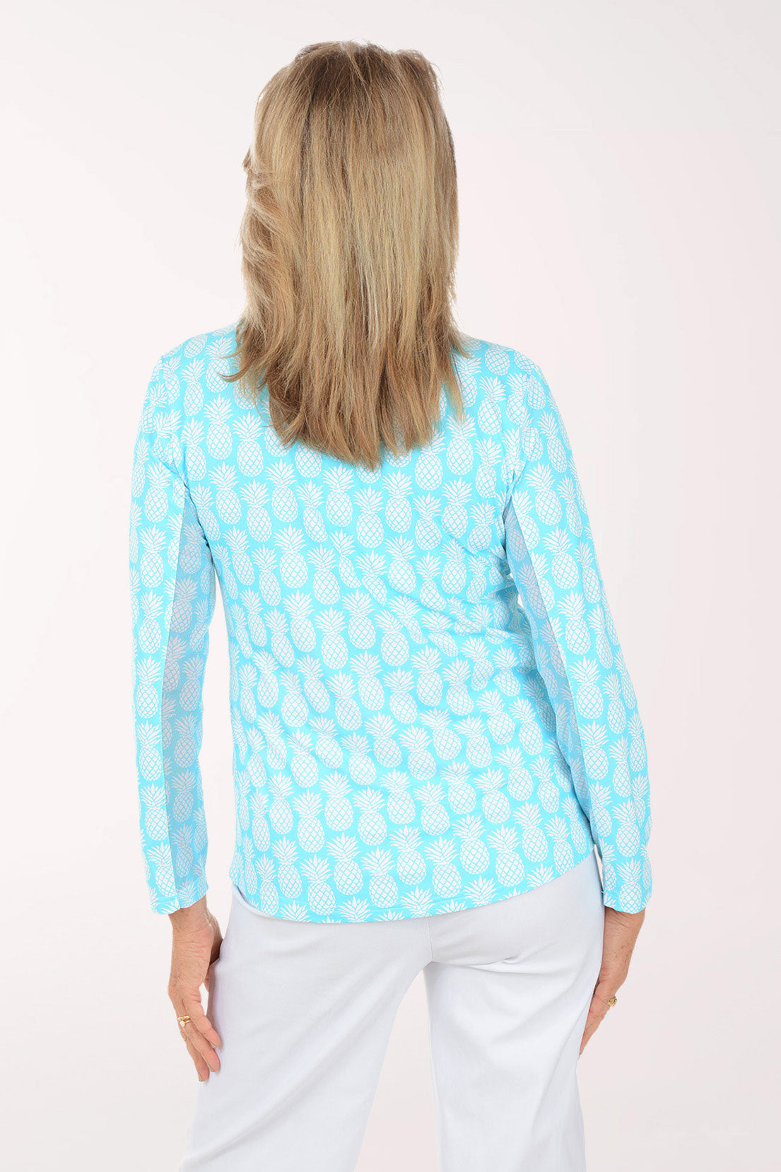 Woman wearing a light blue patterned shirt on a white background