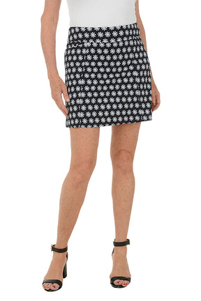Person wearing a black and white patterned skirt on a white background.