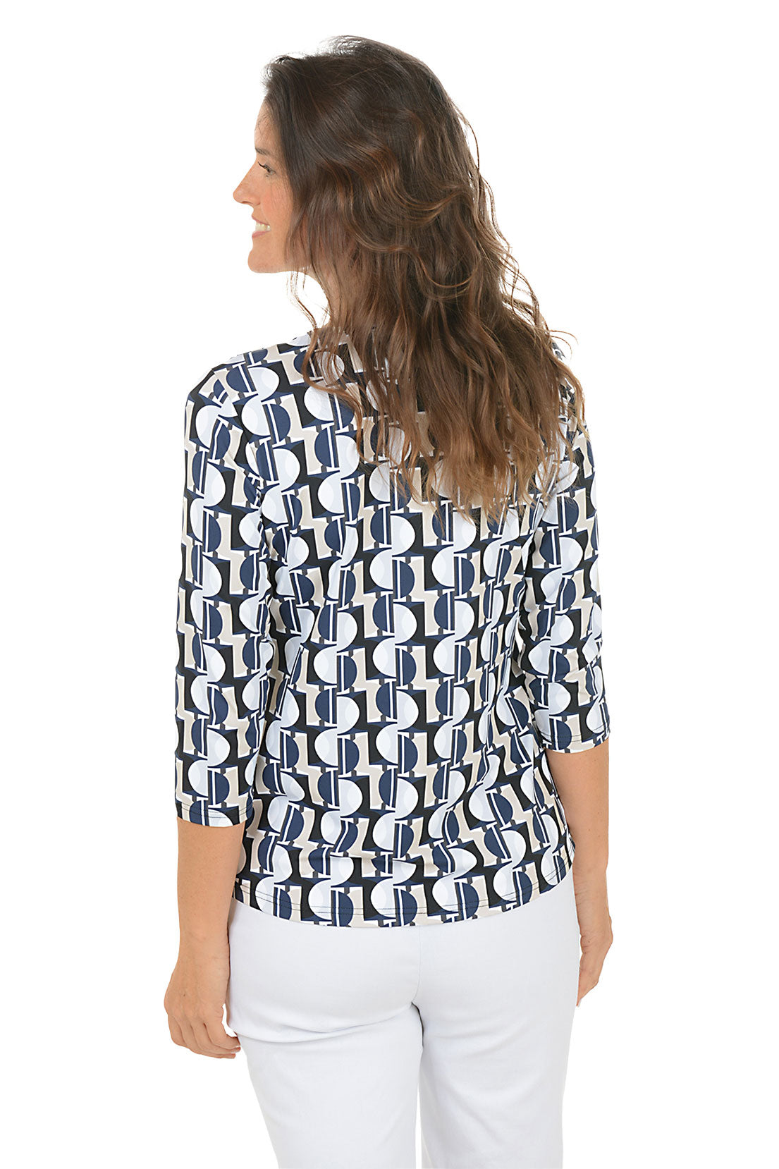 Woman wearing a v-neck 3/4 sleeve half moon geometric patterned blouse in black, tan and blue with a white background. Back shot.