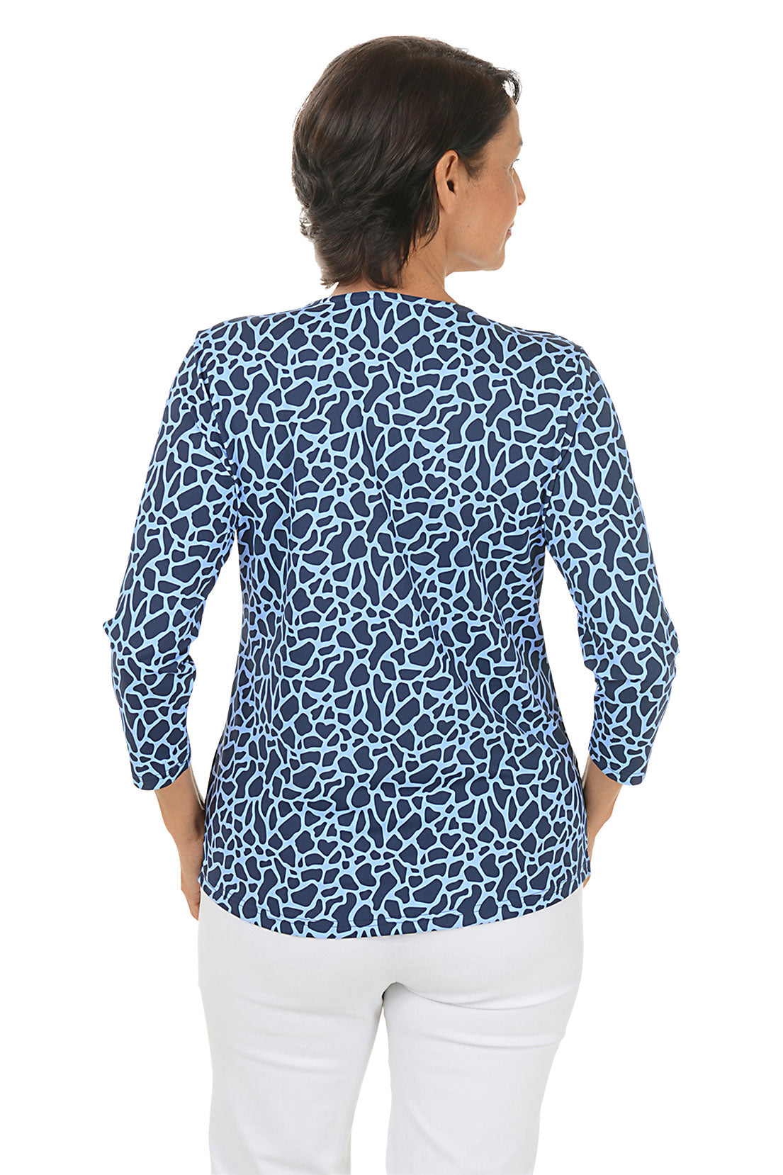 A woman wearing a blue crackled patterned v-neck 3/4 sleeve top. Back shot.