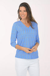 A woman wearing a 3/4 sleeve blue top.
