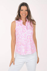A woman wearing a pink and white sleeveless floral top.