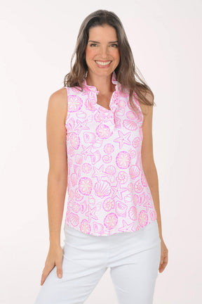 A woman wearing a pink and white sleeveless floral top.
