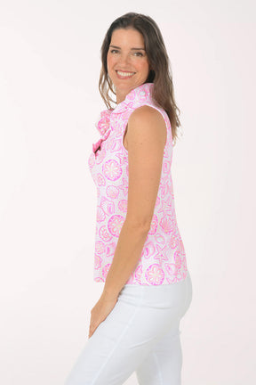 A woman wearing a pink and white sleeveless floral top.