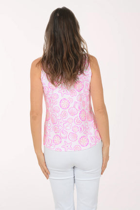 A woman wearing a pink and white sleeveless floral top.