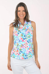 A woman wearing a multicolored sleeveless floral top.