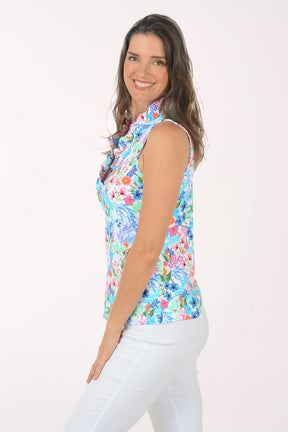 A woman wearing a multicolored sleeveless floral top.