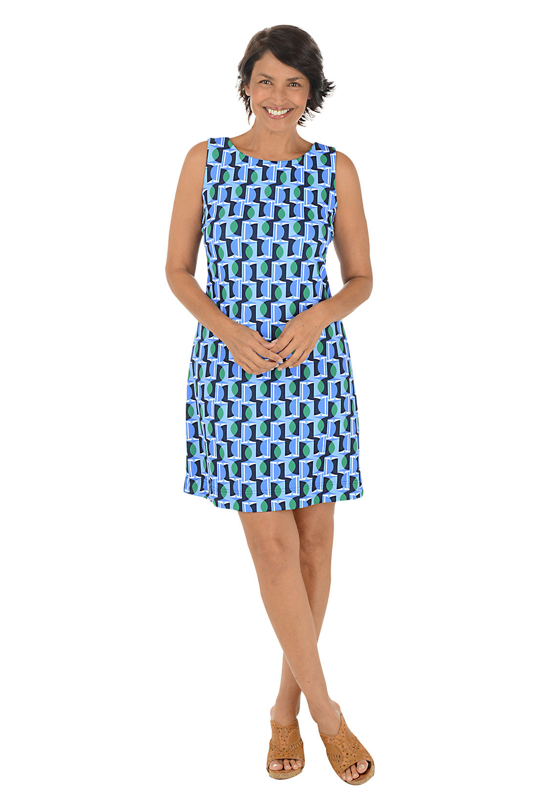 Woman wearing a sleeveless blue geometric patterned dress on a white background.