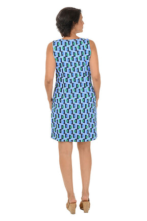 Woman wearing a sleeveless blue geometric patterned dress on a white background. Back shot.