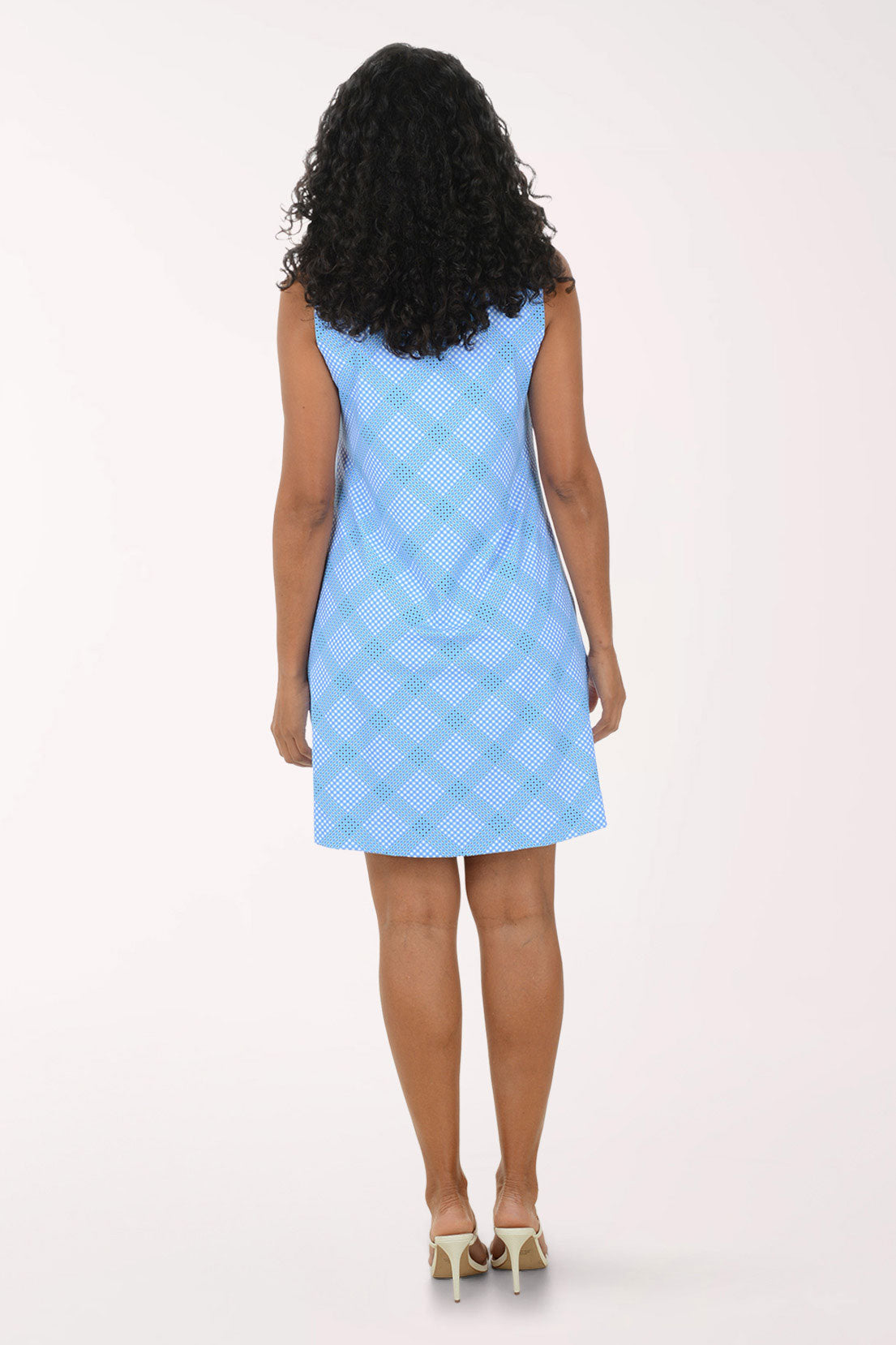 Woman wearing a light blue checkered dress on a white background