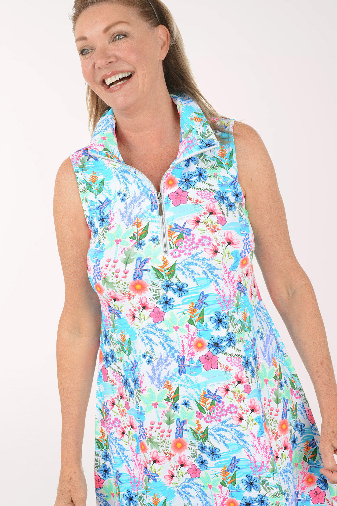 Woman wearing a colorful floral dress on a white background