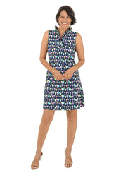Woman wearing a patterned sleeveless dress on a white background.