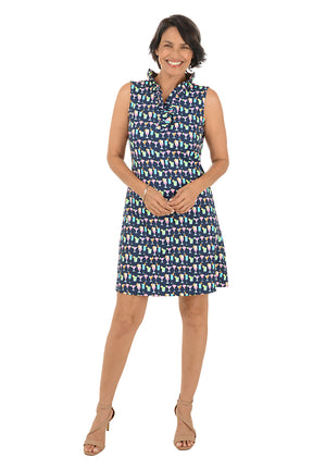 Woman wearing a patterned sleeveless dress on a white background.