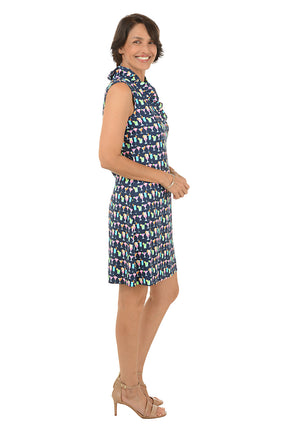 Woman wearing a patterned sleeveless dress on a white background. Side shot.