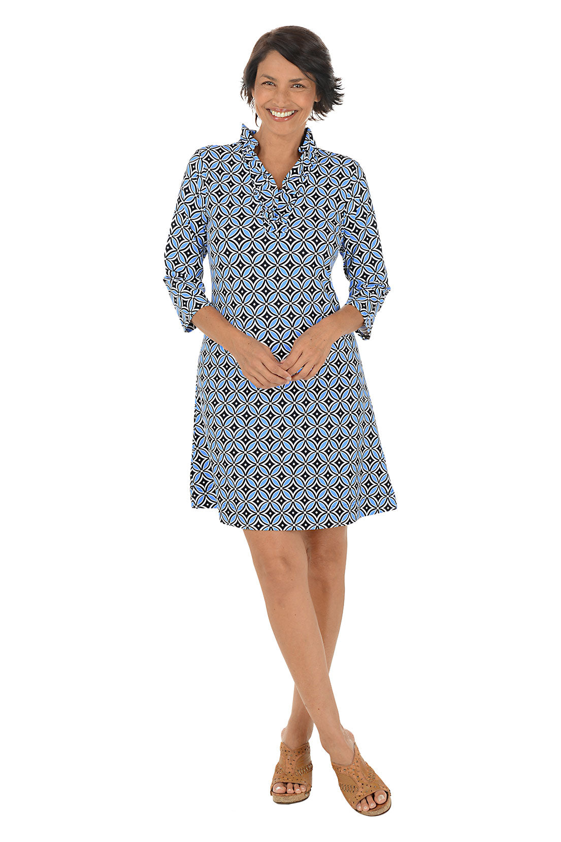 Woman wearing a 3/4 sleeve blue patterned dress on a white background.