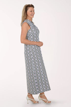 Woman wearing a sleeveless maxi dress with a black and white pattern on a white background.