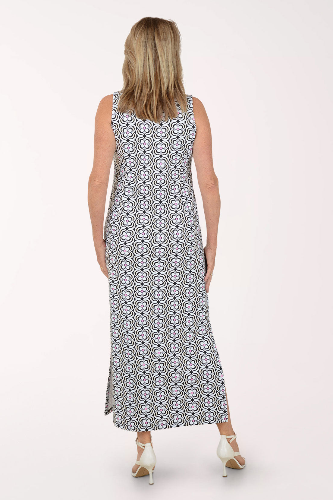 Woman wearing a sleeveless maxi dress with a black and white pattern on a white background.