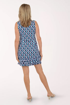 Woman wearing a blue patterned dress on a white background.