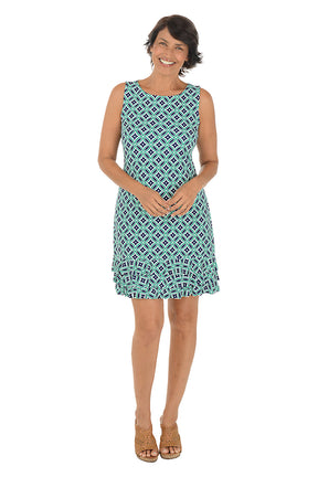 Woman wearing a sleeveless teal patterned dress with a triple ruffled hem on a white background.