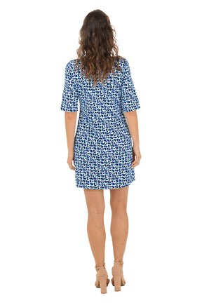 A woman wearing a blue multi 3/4 sleeve v-neck dress. Back shot.