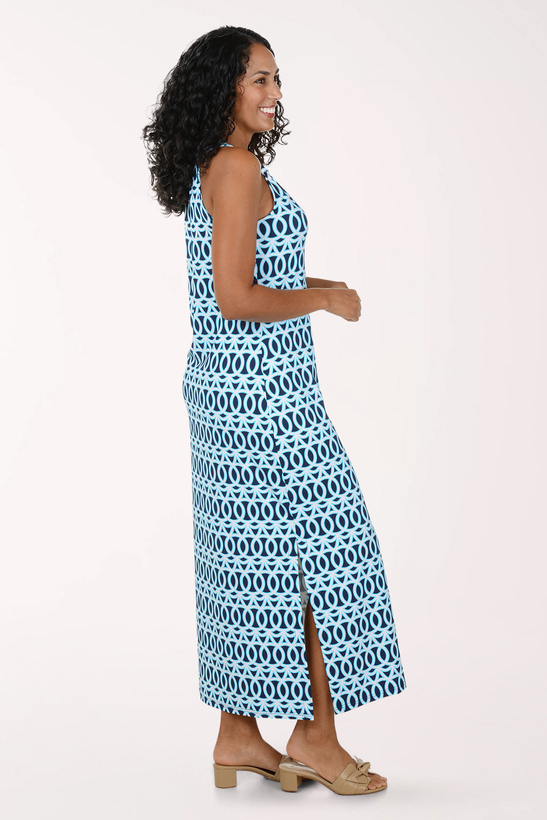 Woman wearing a blue and white patterned maxi dress on a white background.