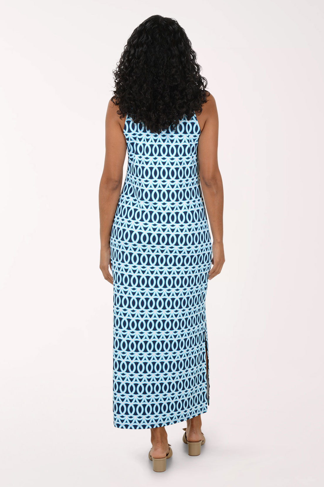 Woman wearing a blue and white patterned maxi dress on a white background.