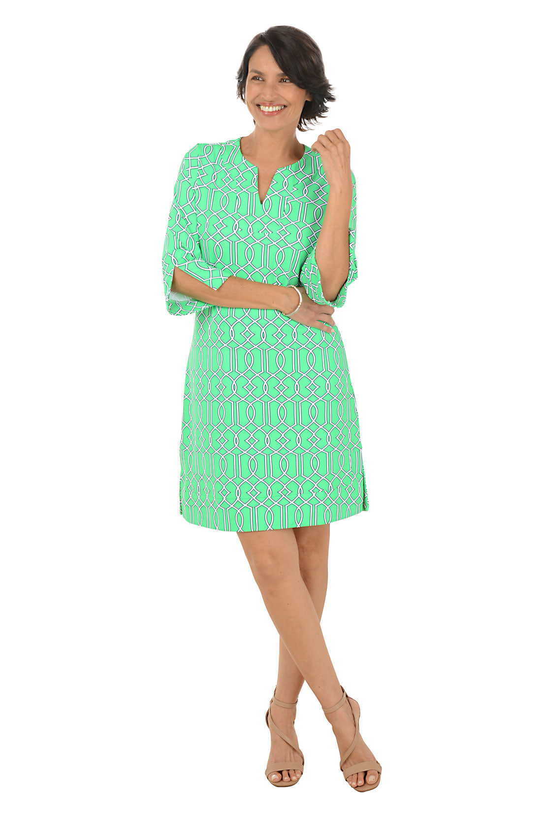 Woman wearing a green patterned dress on a white background. Second front shot.