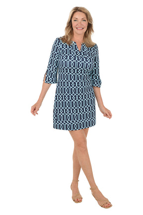 Woman wearing a blue patterned dress on a white background. Second front shot.