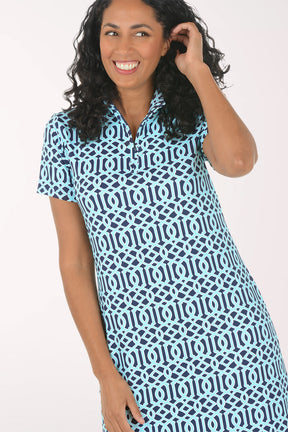 Woman wearing a blue and white patterned dress on a white background.