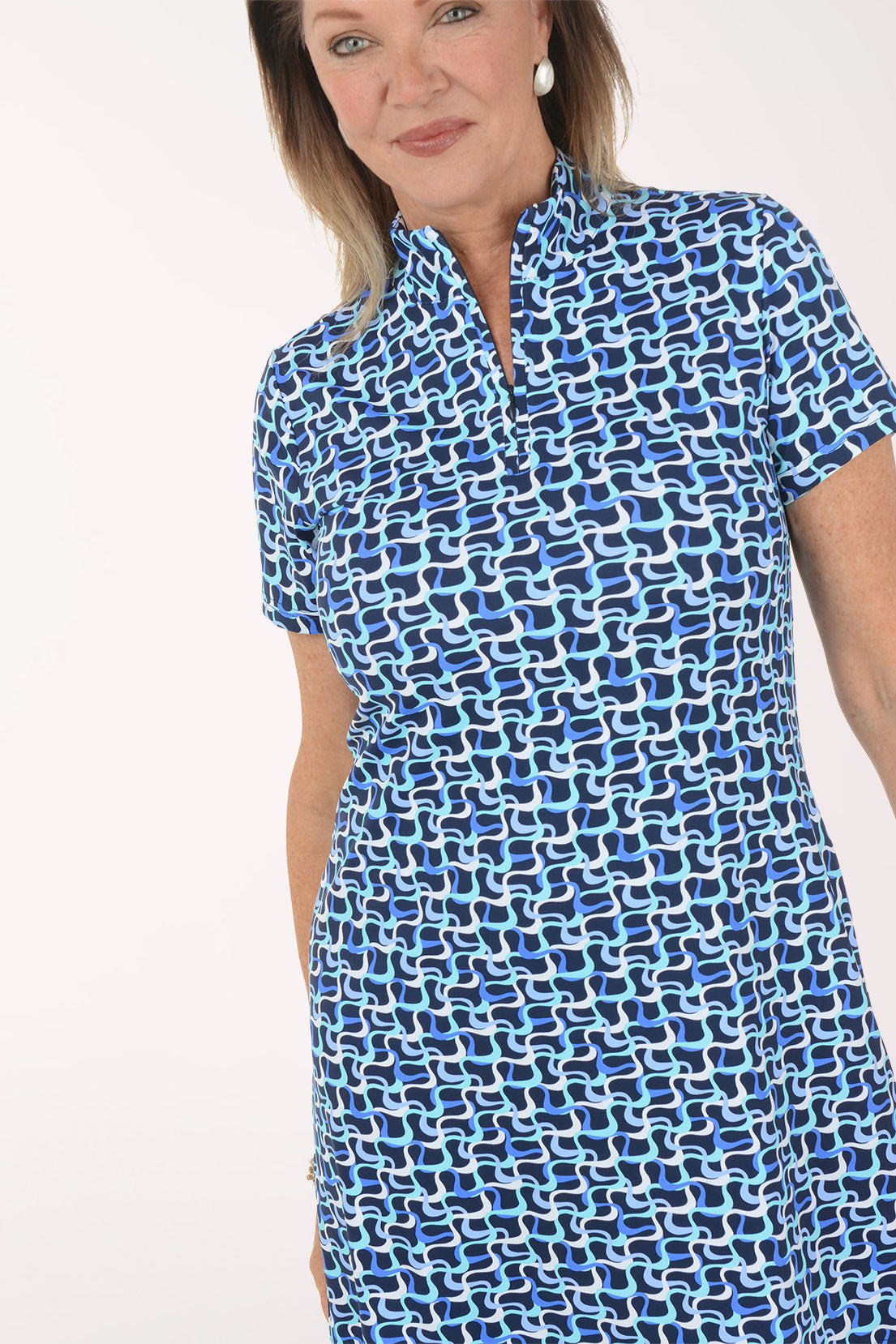 Woman wearing a blue patterned dress on a white background.