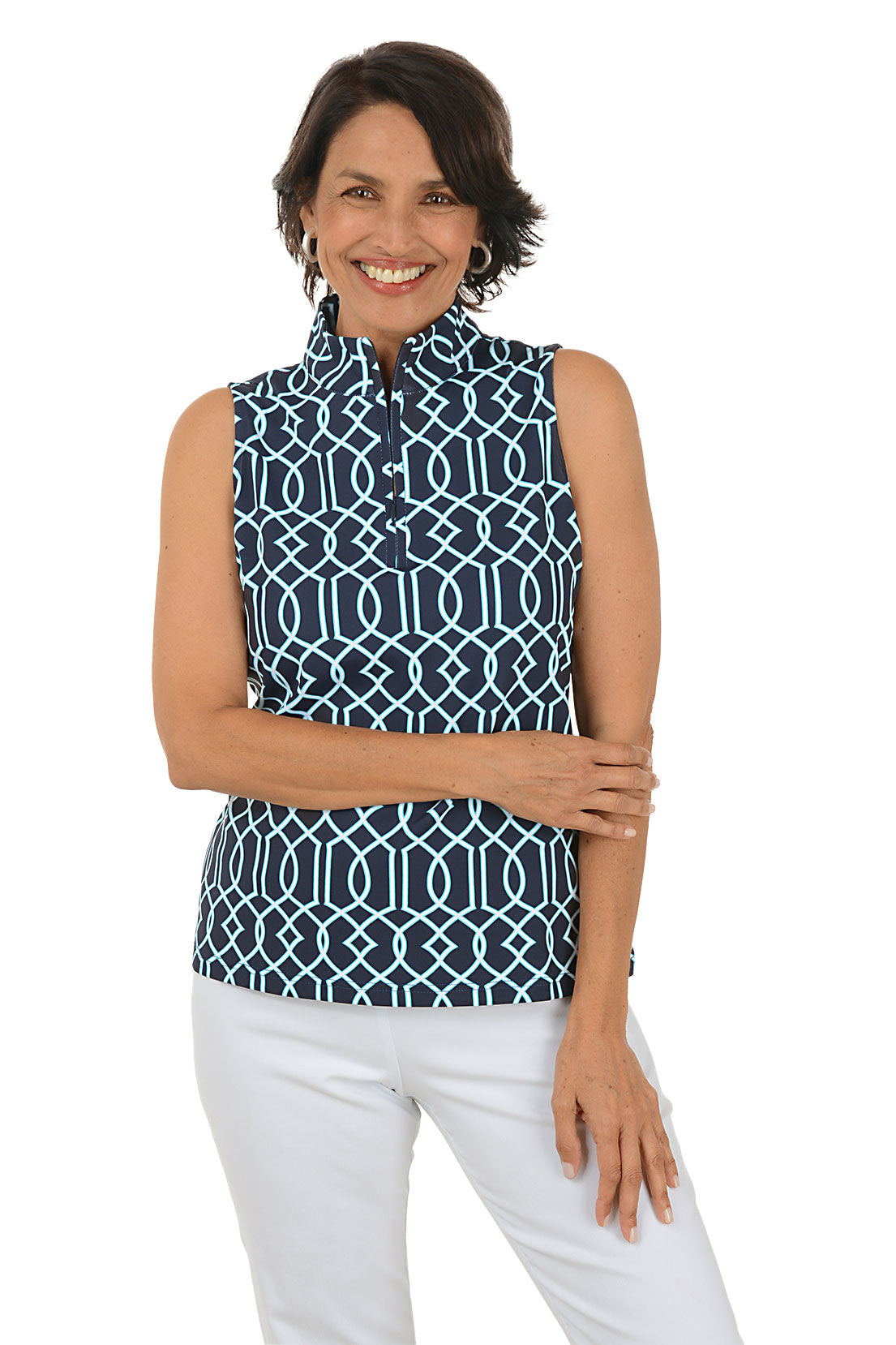 Woman wearing a sleeveless patterned top and white pants on a white background