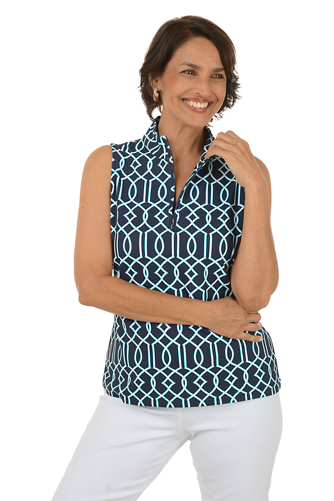 Woman wearing a sleeveless patterned top and white pants on a white background