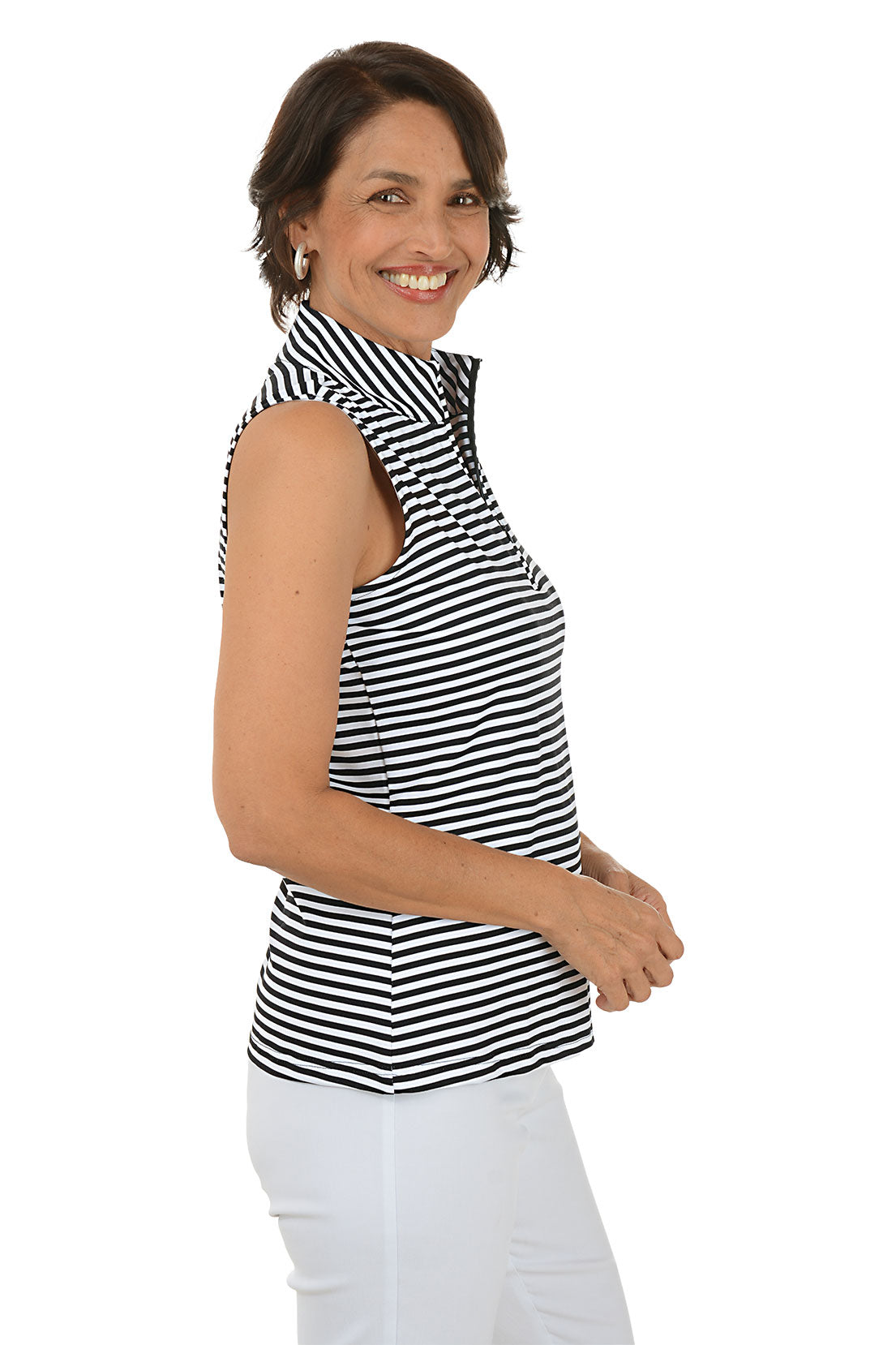 Woman wearing a black and white striped sleeveless top with a collar on a white background. Side shot.