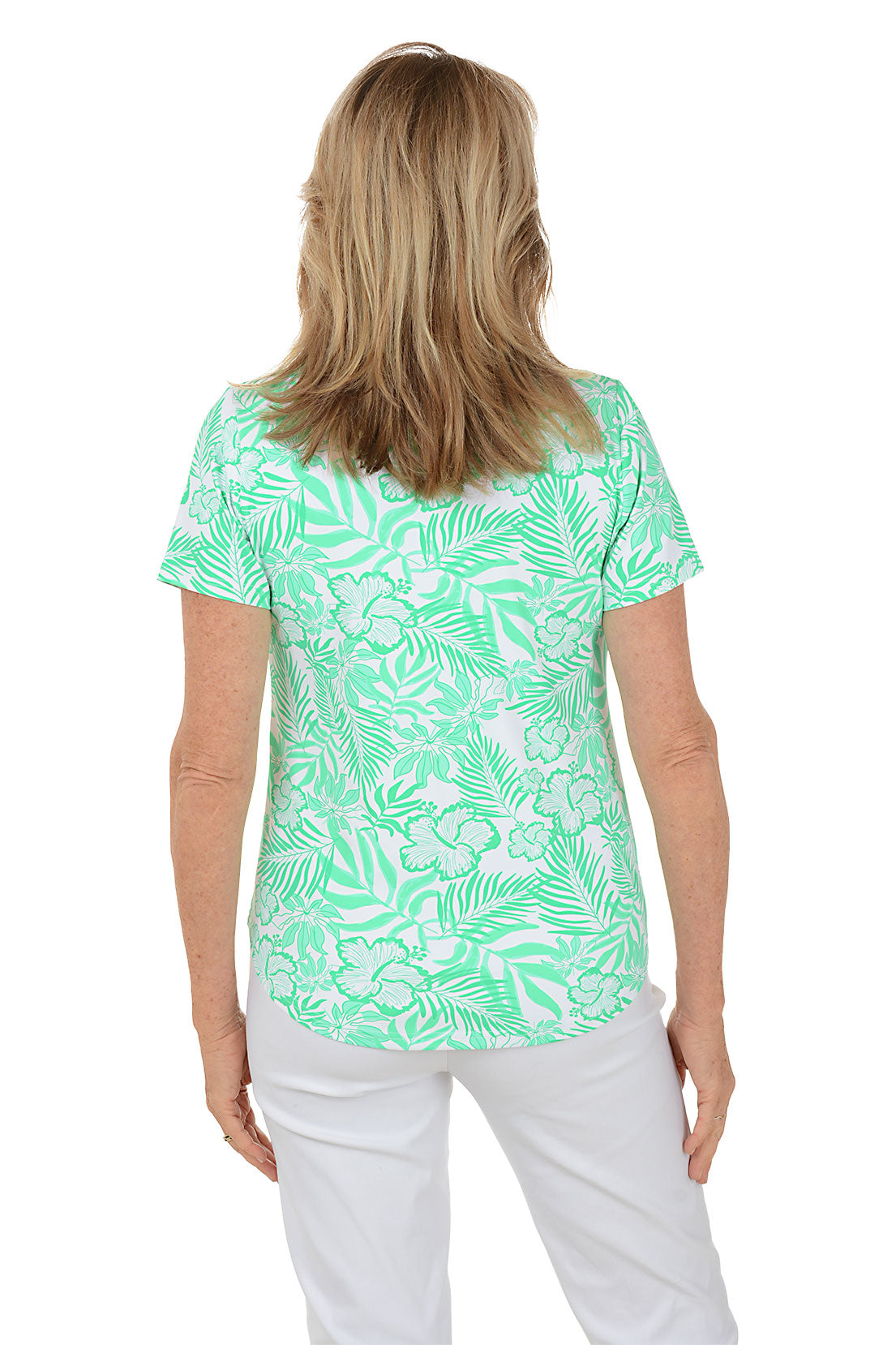 Woman wearing a green floral patterned blouse on a white background. Back shot.