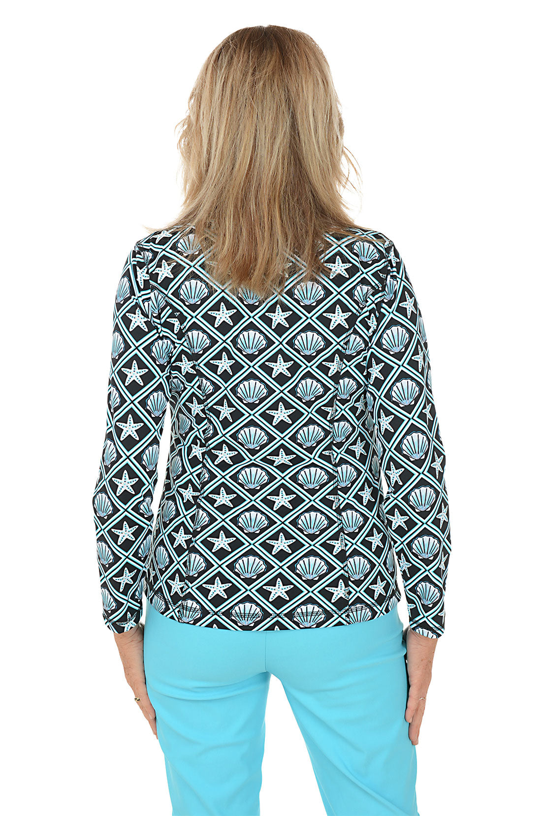 Woman wearing a patterned jacket with starfish and shell design on a white background. Back shot.