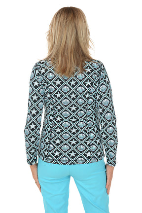Woman wearing a patterned jacket with starfish and shell design on a white background. Back shot.