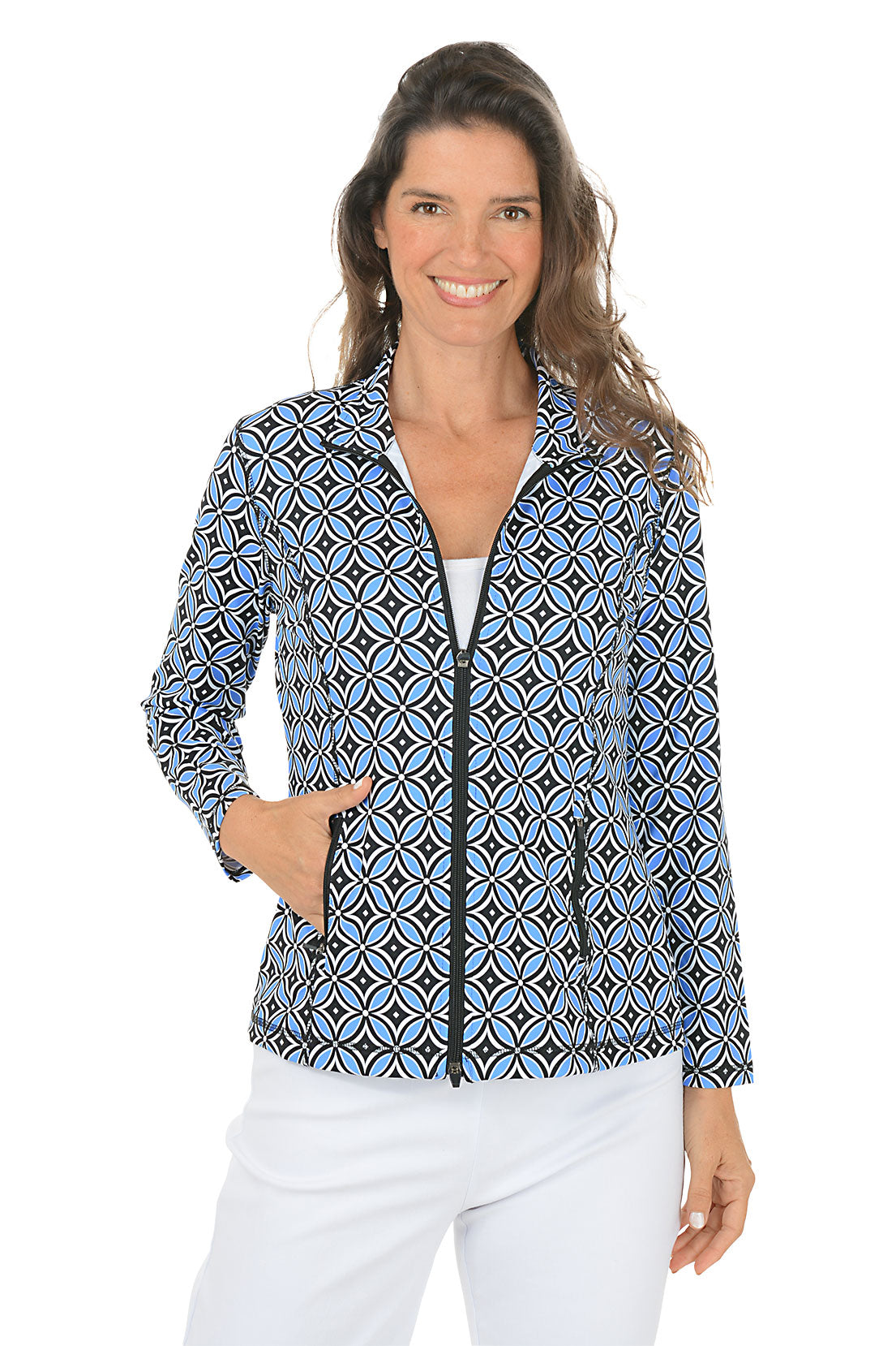 Woman wearing a blue multi patterned jacket with a zipper on a white background.