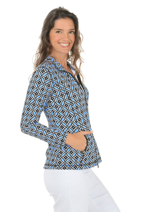 Woman wearing a blue multi patterned jacket with a zipper on a white background. Side shot.