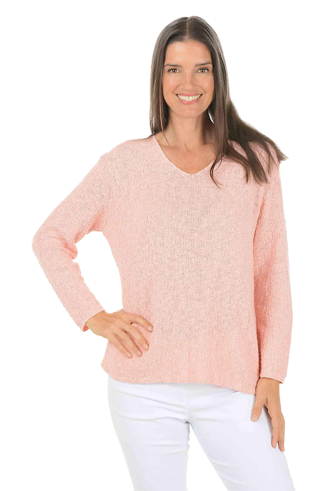 Woman wearing a light pink sweater and white pants on a white background