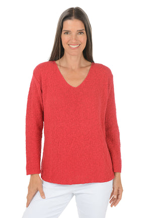 Woman wearing a red sweater on a white background