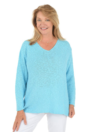 Woman wearing a light blue sweater on a white background