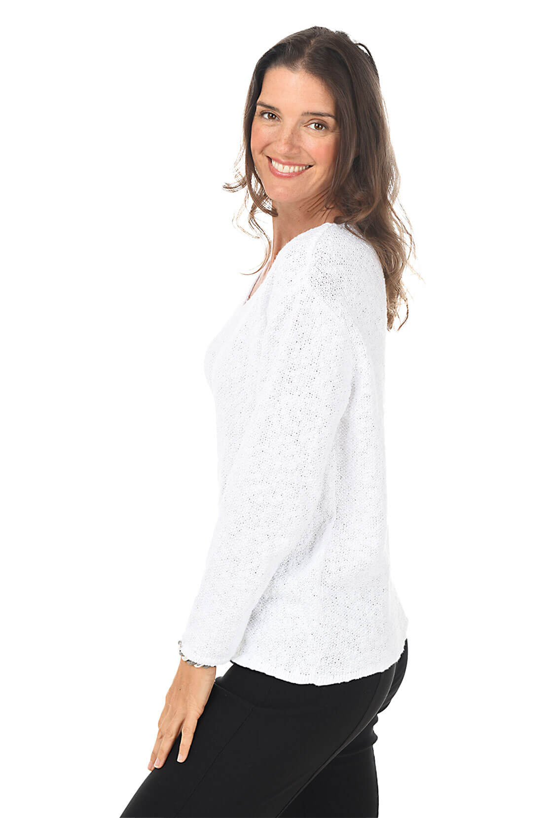 Side shot of a woman wearing a white blouse with a subtle pattern on a white background
