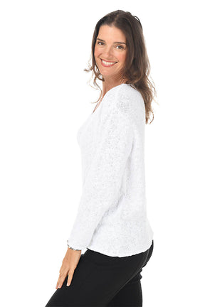 Side shot of a woman wearing a white blouse with a subtle pattern on a white background