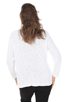 Back shot a person wearing a white patterned sweater on a white background